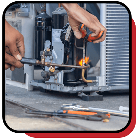 Zark Heating & Cooling technician repairing an air conditioner