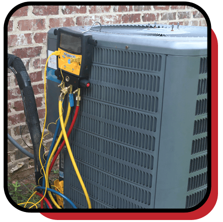 Zark Heating & Cooling technician checking an air conditioner during a tune-up