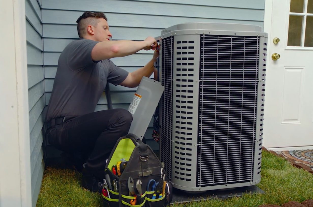A man working on a heat pump in New Lenox, IL