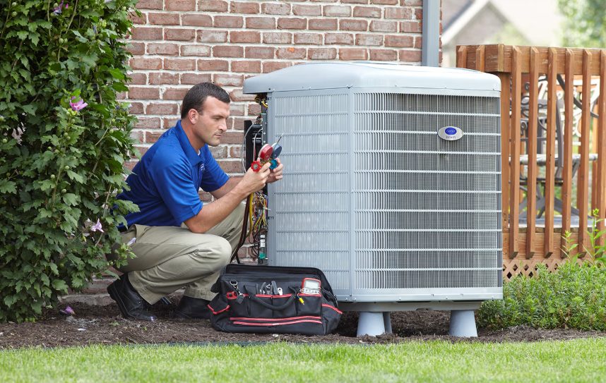 A man working on an HVAC heat pump in New Lenox, IL